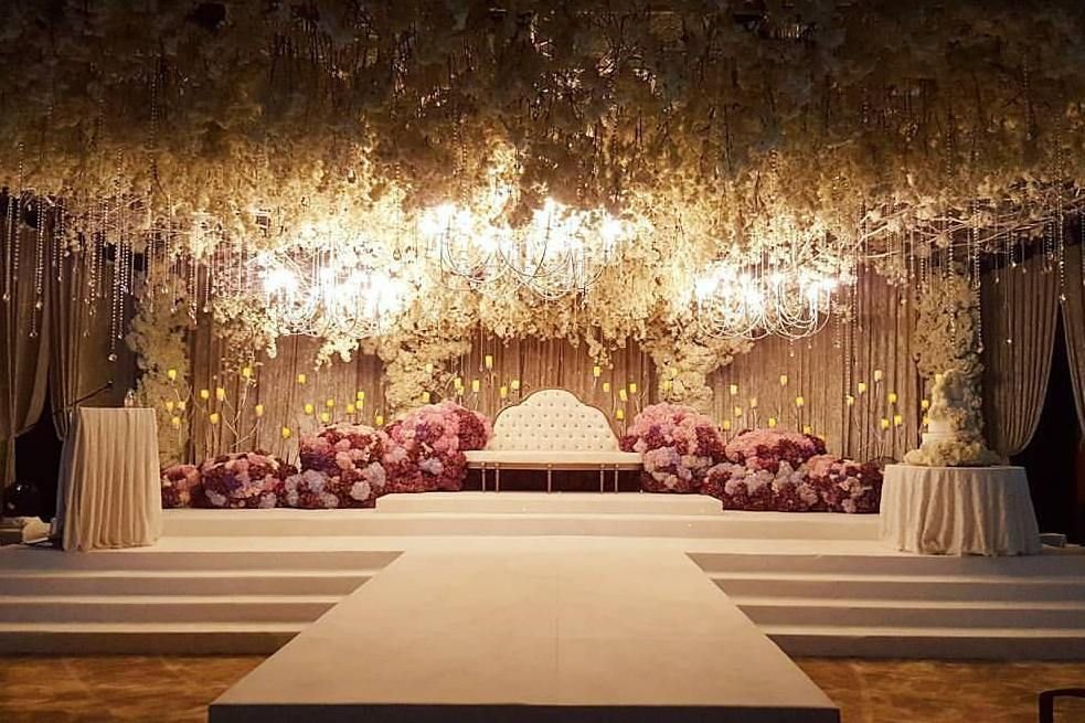 Dreamy engagement night décor setup with candles and draped staging